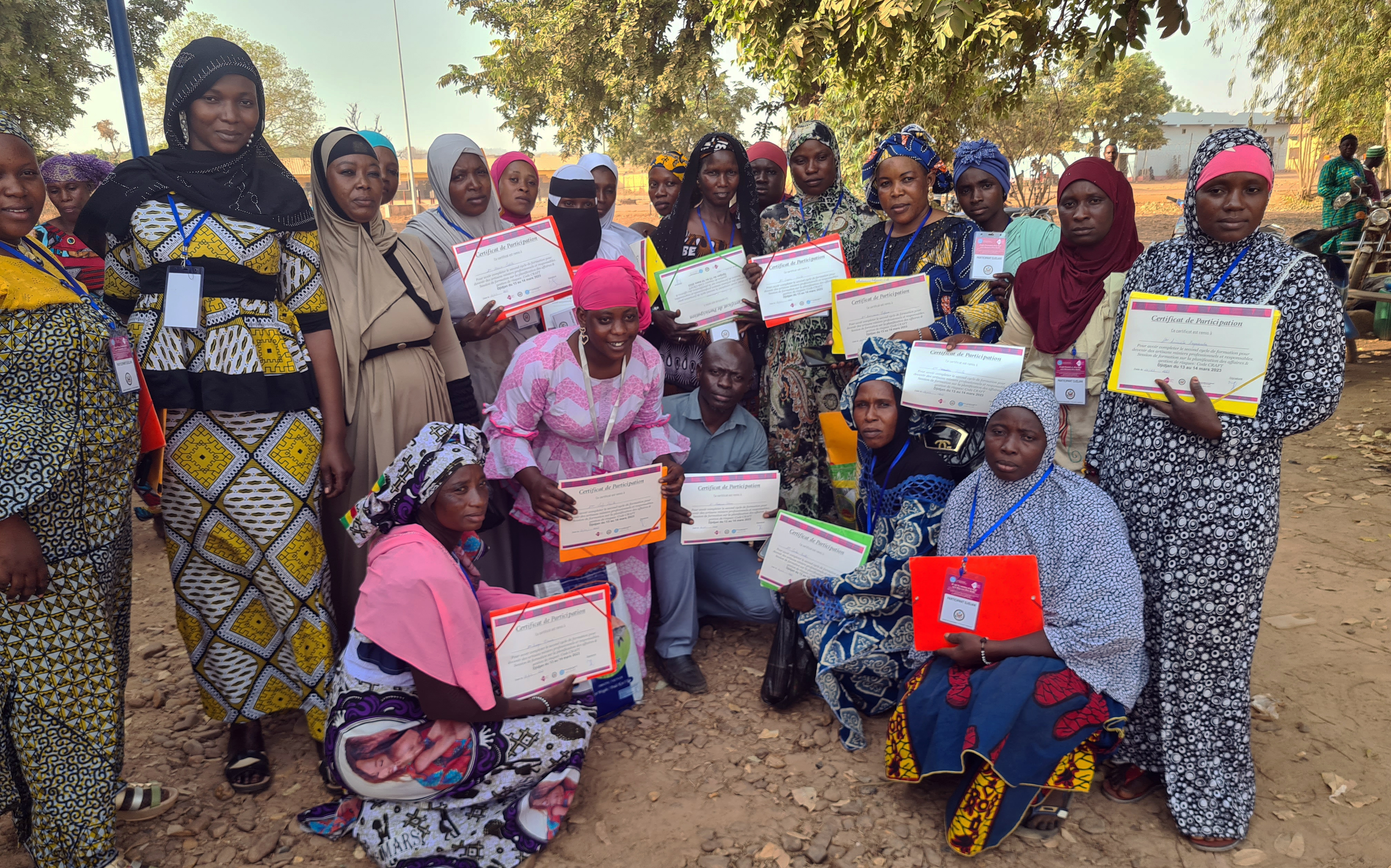 Women miners of Djeka Baara Cooperative in Keniéba, Mali, showing their certificates after completing a formalization training by Pact (Photo by Jorden de Haan)