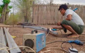 Setting up installation for solar panels in Myanmar. Photo credit: Pact.